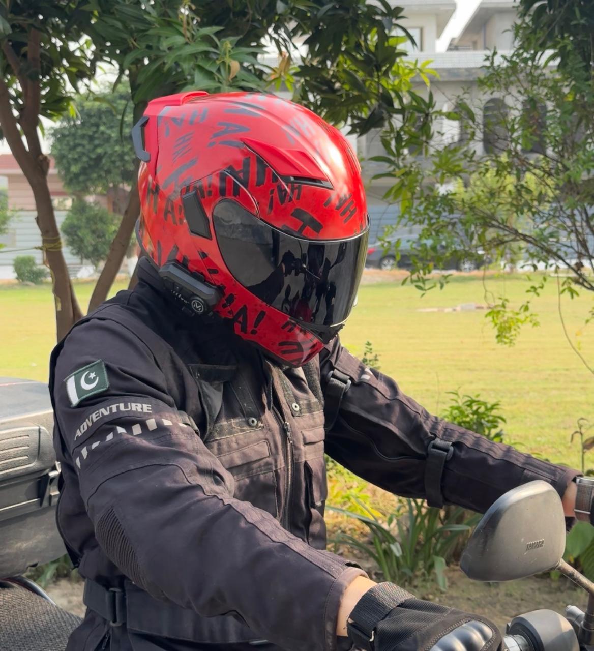 Rider wearing a helmet with an unlaminated red and black printed wrap